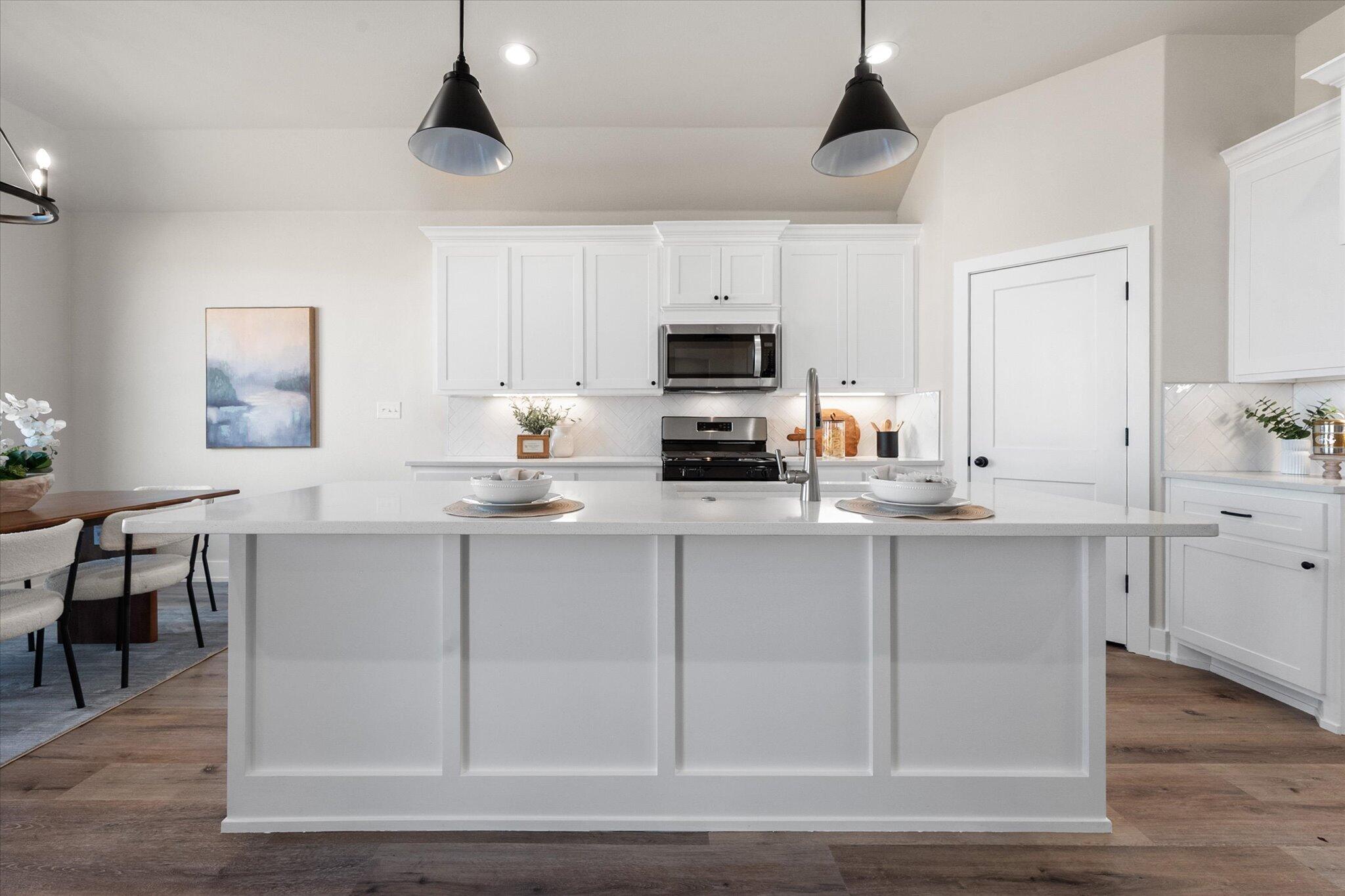 1404 Durham Avenue Wolfforth, TX 79382 - Photo 10 of 34 a kitchen with cabinets a sink and appliances