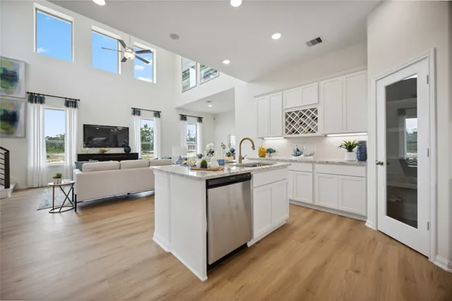 a kitchen with white cabinets and stainless steel appliances