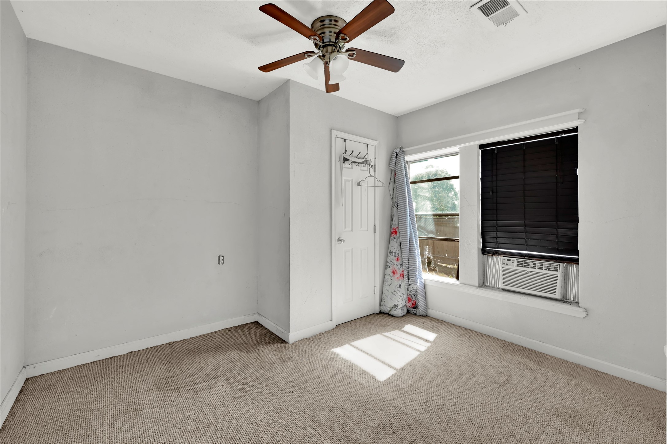 720 Yupon Street Baytown, TX 77520 - Photo 11 of 15 a view of a livingroom with a ceiling fan and window