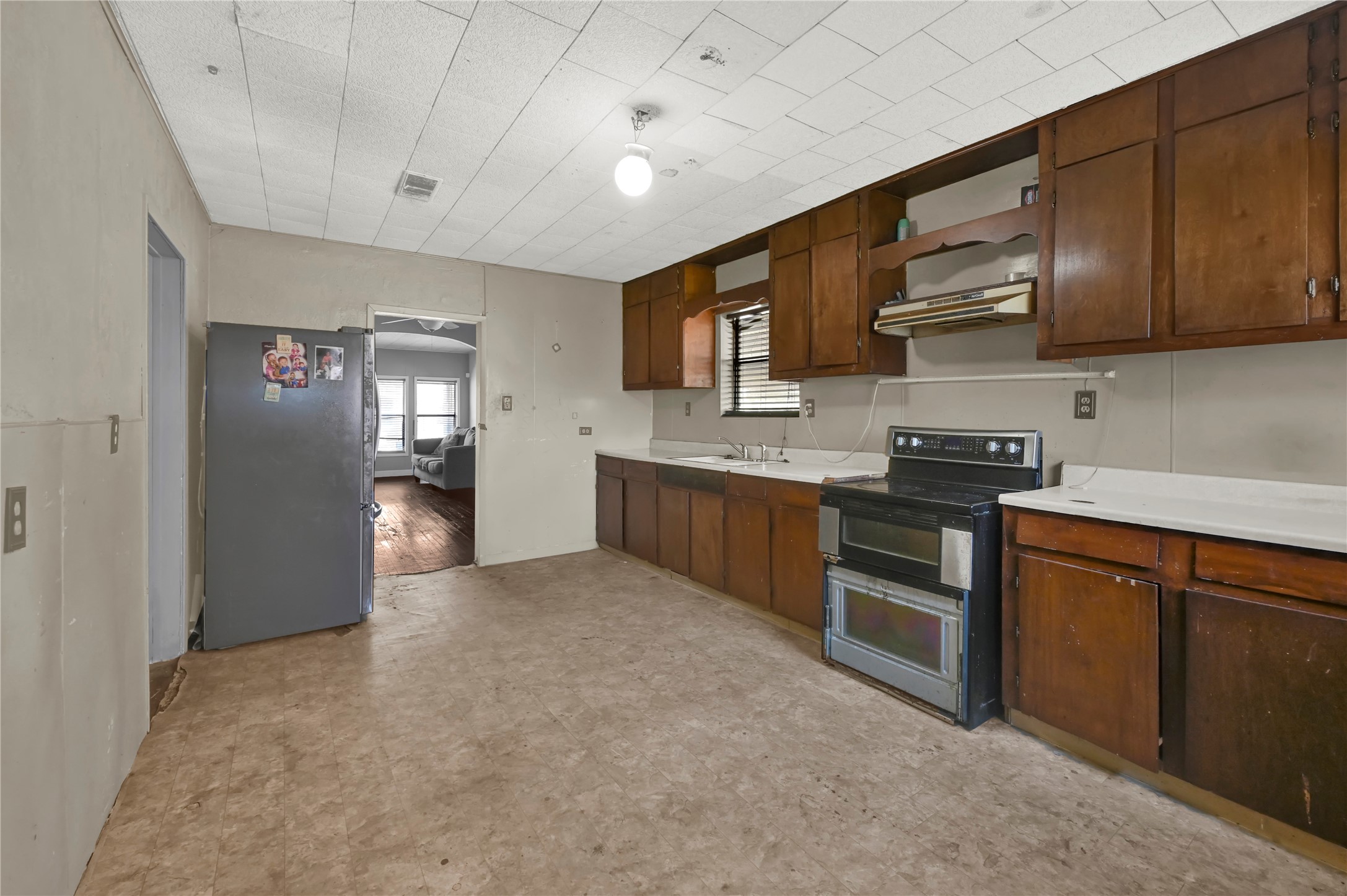 720 Yupon Street Baytown, TX 77520 - Photo 13 of 15 a kitchen with stainless steel appliances granite countertop a refrigerator stove and sink