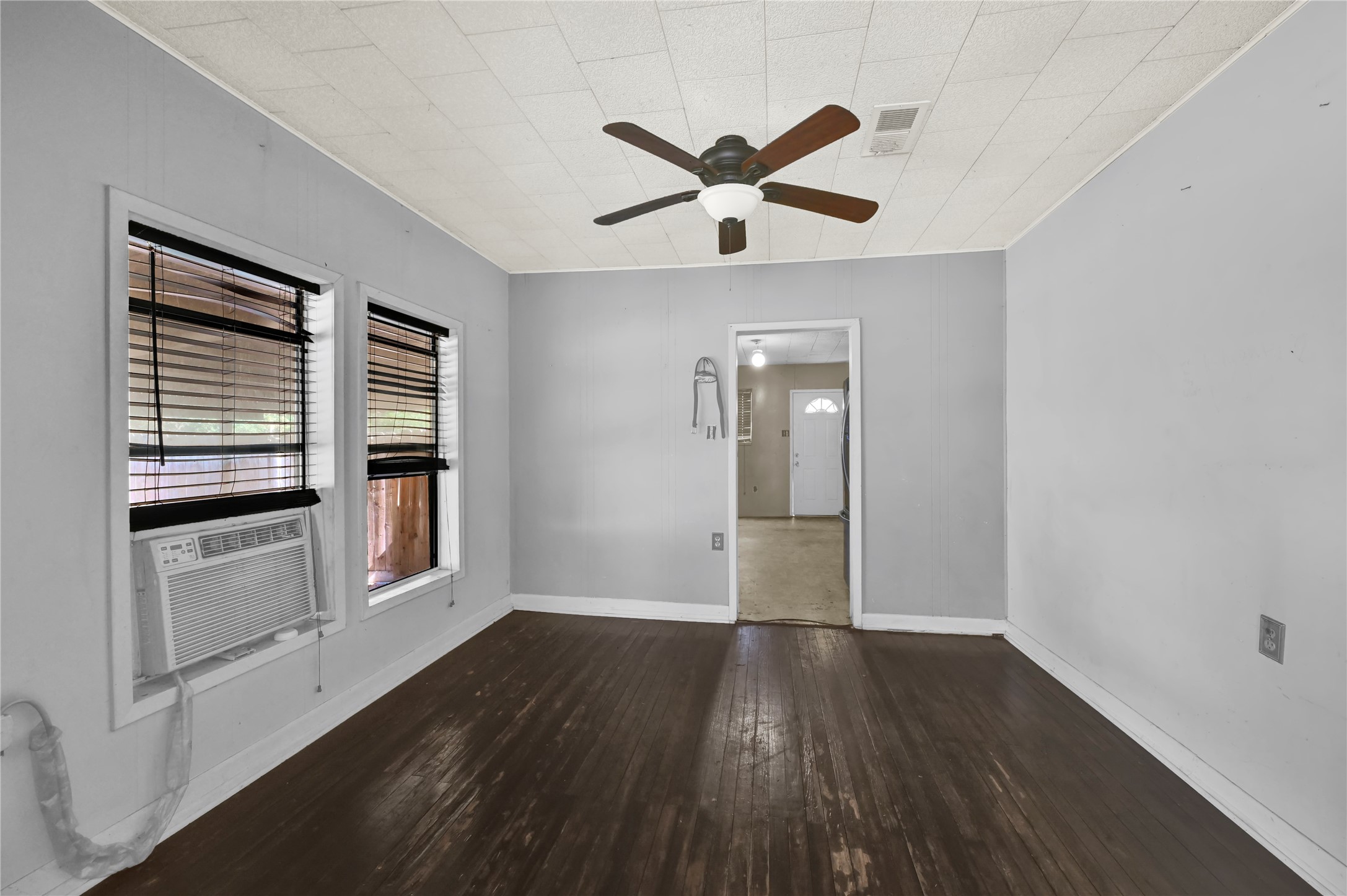 720 Yupon Street Baytown, TX 77520 - Photo 6 of 15 a view of empty room with wooden floor and fan