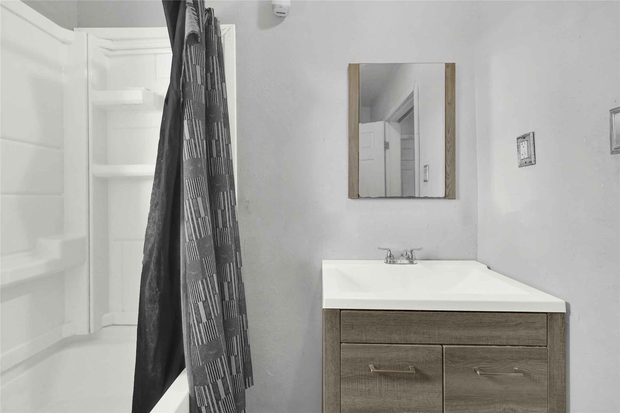 720 Yupon Street Baytown, TX 77520 - Photo 10 of 15 a bathroom with a sink and mirror