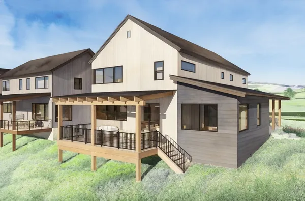 a view of a house with a yard and sitting area