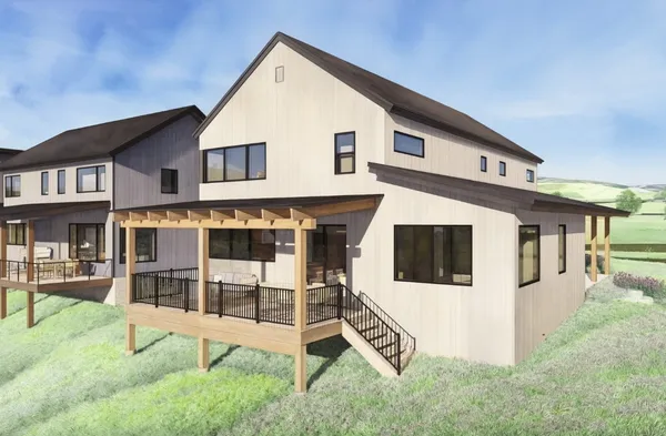 a view of a white house with large windows and a yard