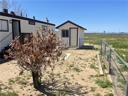 11985 Gaskell Road Rosamond, CA 93560 - Photo 11 of 12 a view of a backyard with plants and lake view