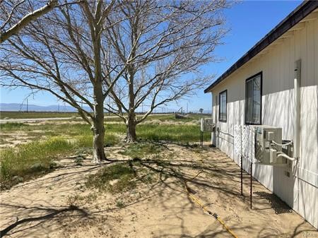 11985 Gaskell Road Rosamond, CA 93560 - Photo 4 of 12 a view of a yard with wooden fence