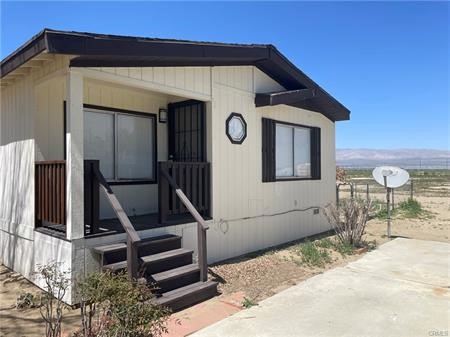 11985 Gaskell Road Rosamond, CA 93560 - Photo 6 of 12 a front view of a house with a yard