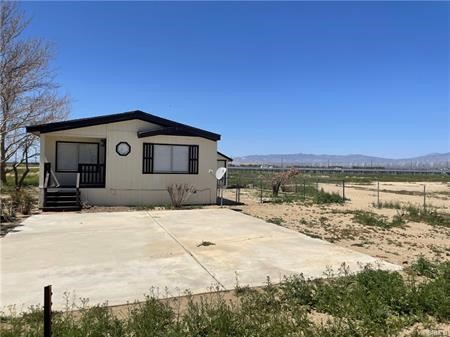 11985 Gaskell Road Rosamond, CA 93560 - Photo 7 of 12 a front view of a house with a yard