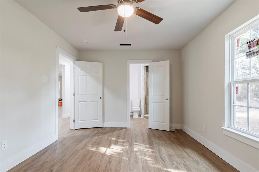 2029 Lynnhaven Road Fort Worth, TX 76103 - Photo 7 of 13 Spacious interior with wood-finish flooring, white trim, and light-colored walls