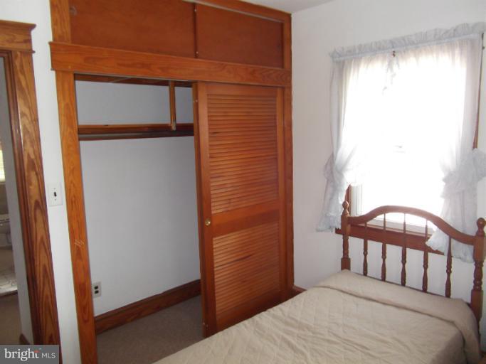 5553 Ashbourne Road Halethorpe, MD 21227 - Photo 22 of 23 a bedroom with a bed and a window