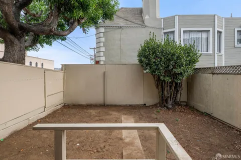 a view of backyard with a table and chairs and a fire pit