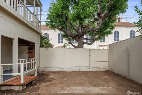 a view of a bench with a bench in front of house