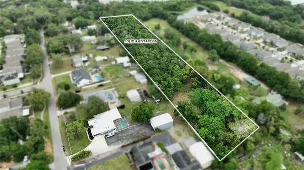 an aerial view of a residential houses with street