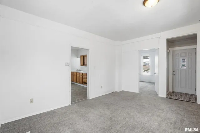 an empty room with an entrance to other room