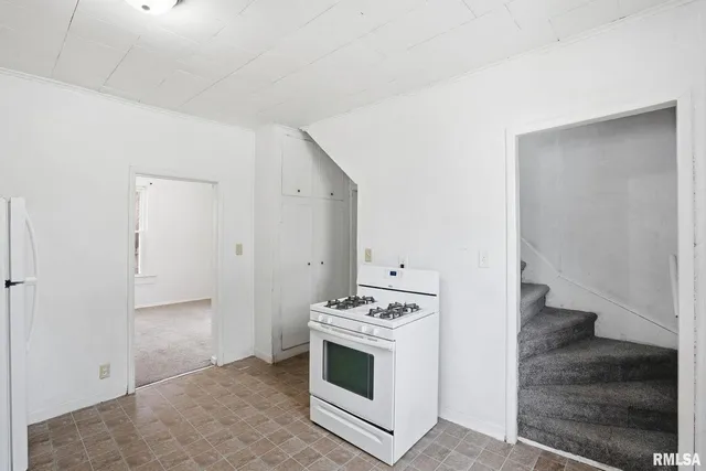 a view of kitchen with white cabinets and white appliances