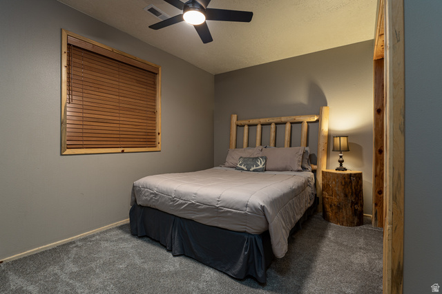 1505 West Elk Ridge Drive Alton, UT 84710 - Photo 31 of 53 Carpeted bedroom featuring ceiling fan and a textured ceiling