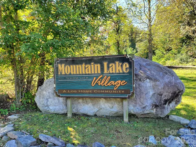 a sign that is sitting on a wooden fence