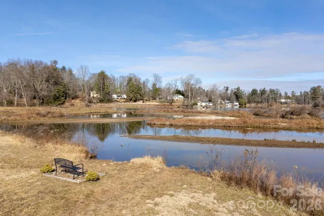 a view of a lake with houses in the back