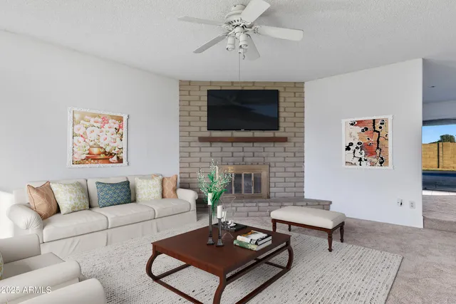 a living room with furniture a rug and a fireplace