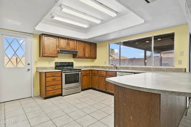 a kitchen with a stove a sink and a refrigerator