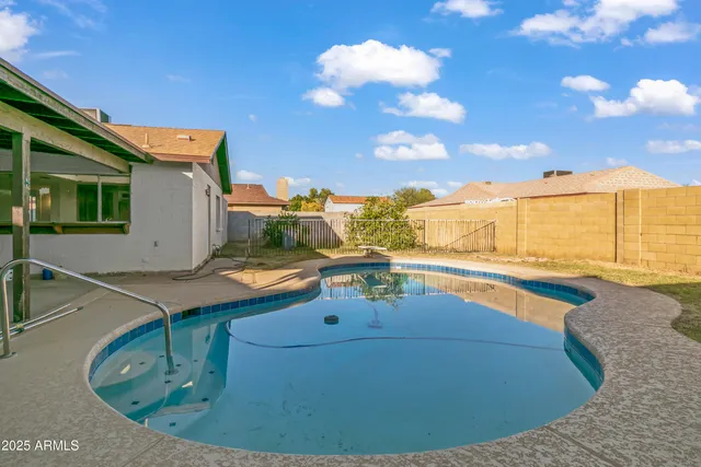 a view of a swimming pool with an outdoor seating