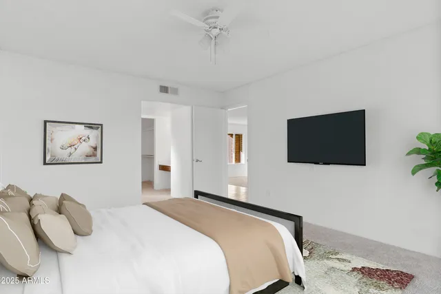 a bedroom with a bed and a flat screen tv