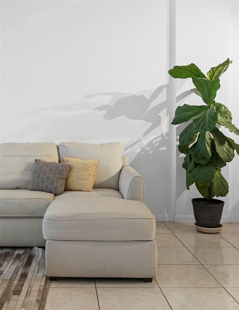 5001 Collins Avenue, Unit 5E Miami Beach, FL 33140 - Photo 15 of 17 a living room with furniture and a potted plant