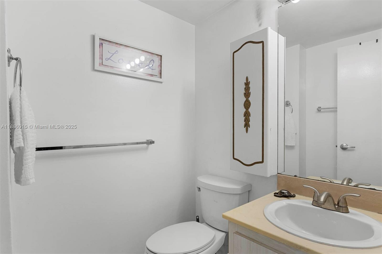 5001 Collins Avenue, Unit 5E Miami Beach, FL 33140 - Photo 16 of 17 a bathroom with a sink toilet and shower