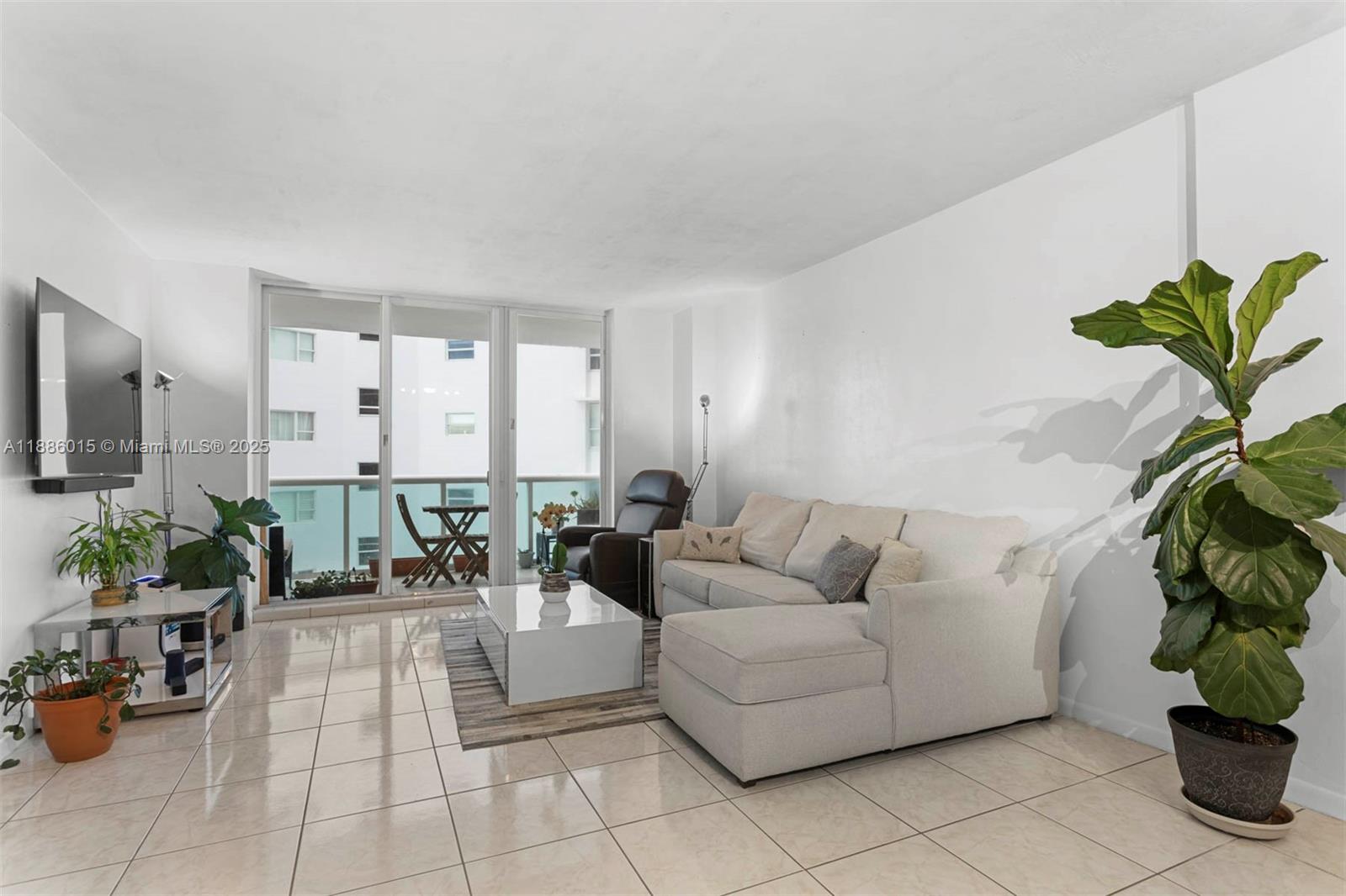 5001 Collins Avenue, Unit 5E Miami Beach, FL 33140 - Photo 3 of 17 a living room with furniture flowerpot and flower pot