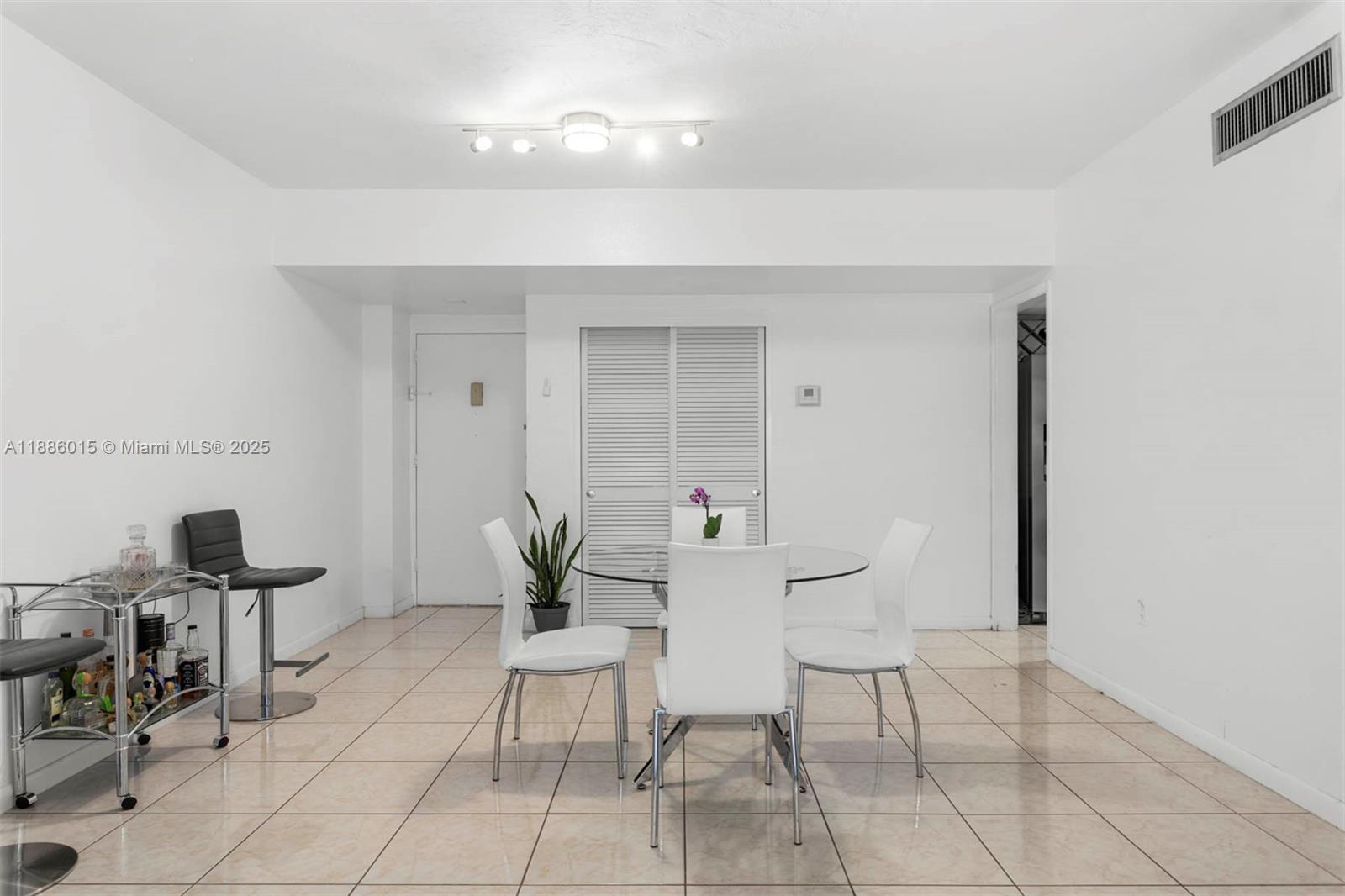 5001 Collins Avenue, Unit 5E Miami Beach, FL 33140 - Photo 7 of 17 a living room with furniture and a potted plant