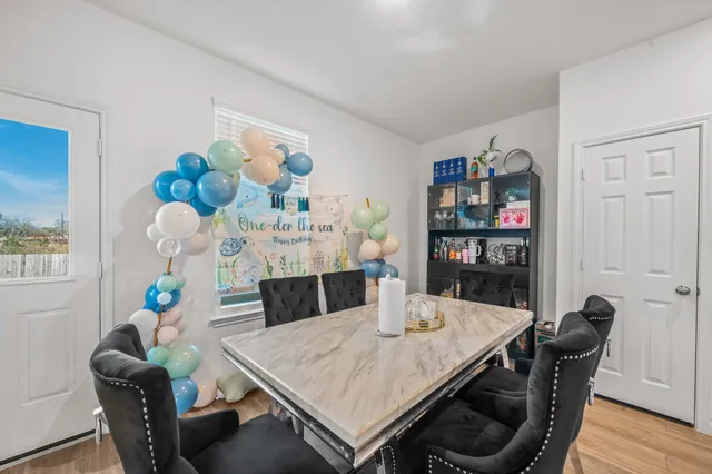 a view of a dining room with furniture and chandelier