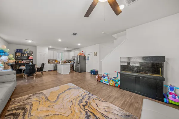 a kitchen with stainless steel appliances kitchen island granite countertop a refrigerator and microwave