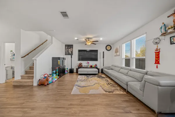a living room with furniture and wooden floor