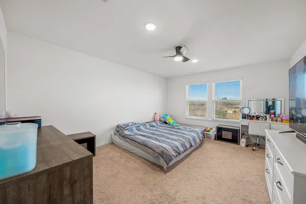 a spacious bedroom with a bed and a table in it