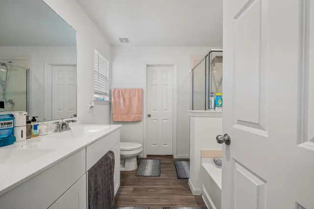 a bathroom with a sink toilet and shower