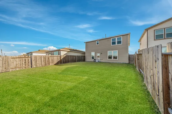 a view of a house with backyard and a garden