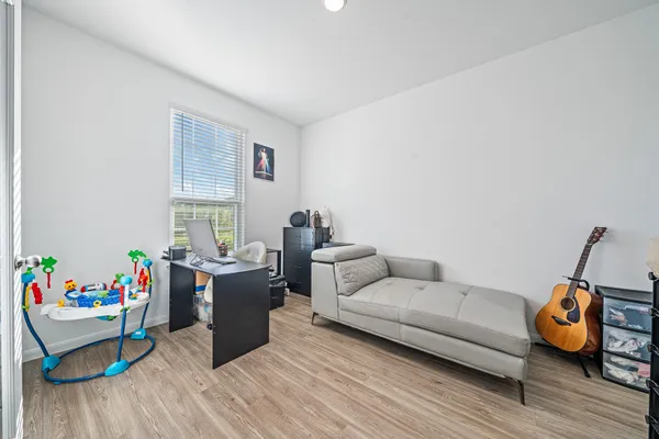 a living room with furniture and a wooden floor