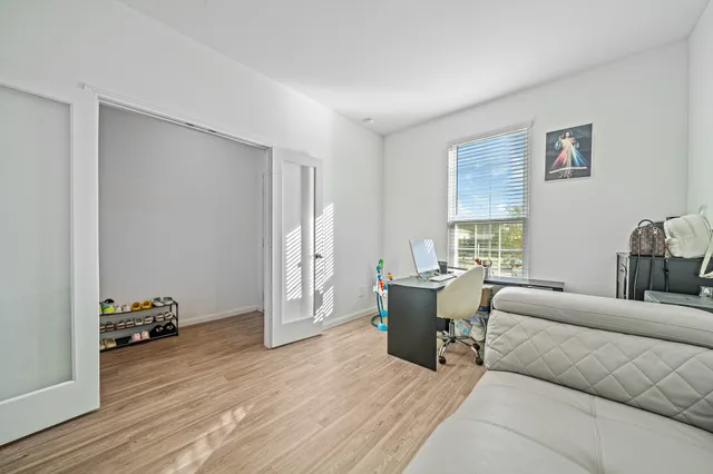 a living room with furniture a wooden floor and a window
