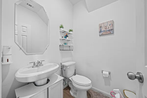 a bathroom with a toilet sink and mirror