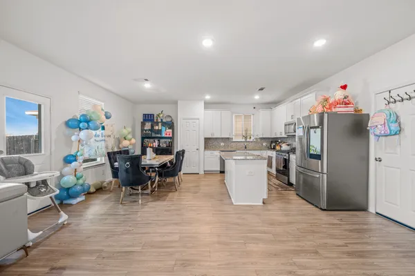 a living room with furniture and kitchen view