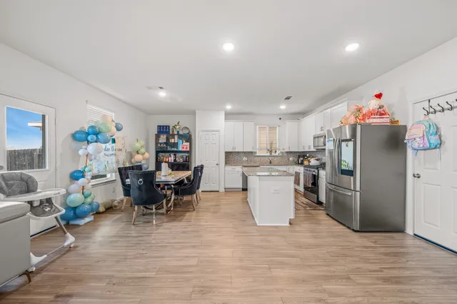 a living room with furniture and kitchen view