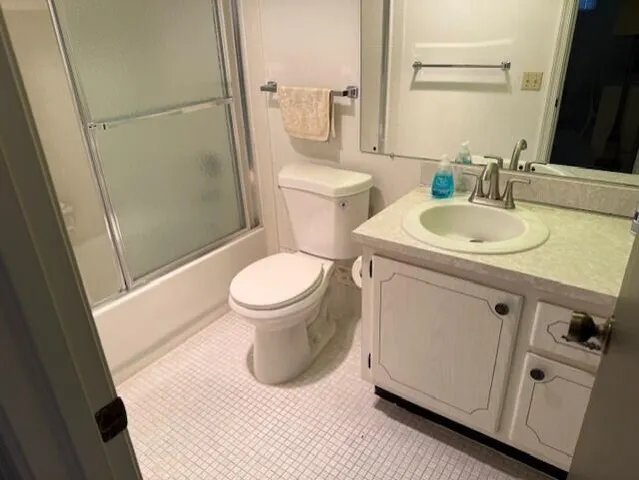 a white toilet sitting next to a bath tub