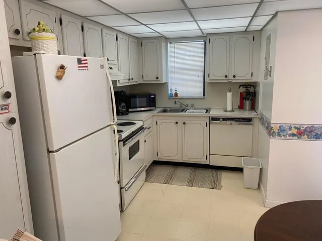 a white refrigerator freezer sitting in a kitchen