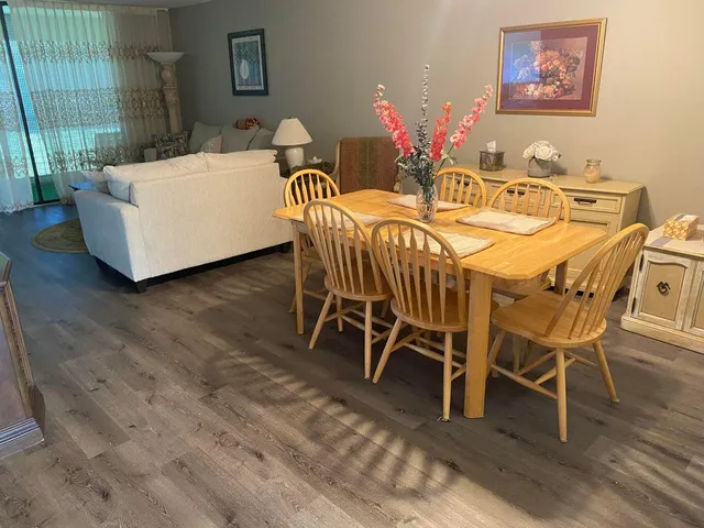 a view of a dining room with furniture window and wooden floor