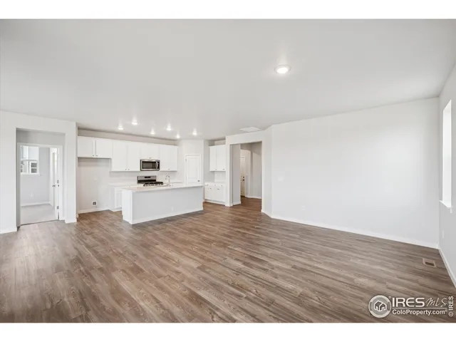 a kitchen with stainless steel appliances kitchen island sink refrigerator and stove