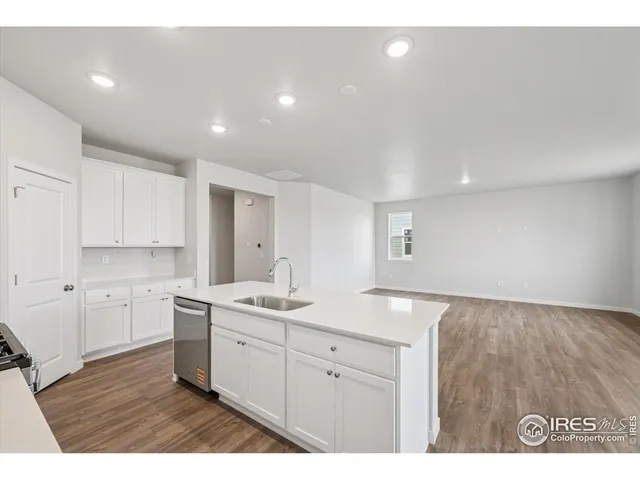 a view of kitchen with sink and wooden floor