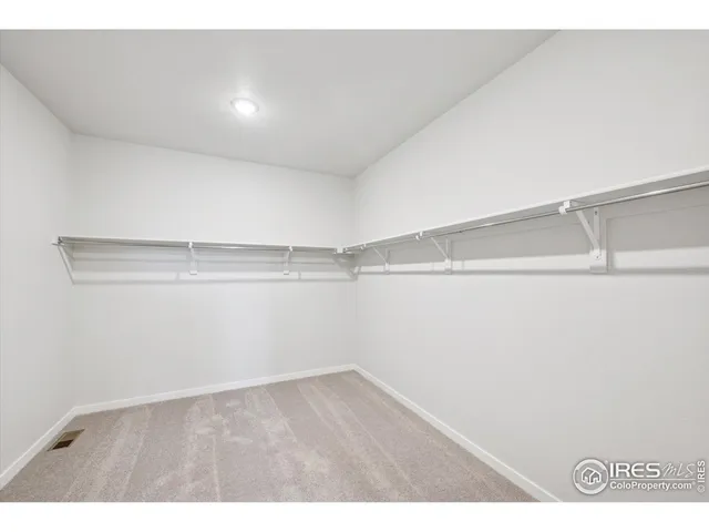 a bathroom with a double vanity sink a mirror and a shower