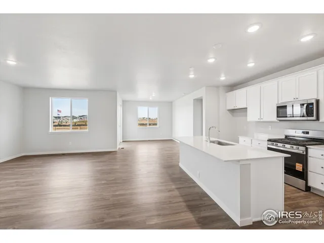 a view of kitchen with stainless steel appliances refrigerator oven and cabinets