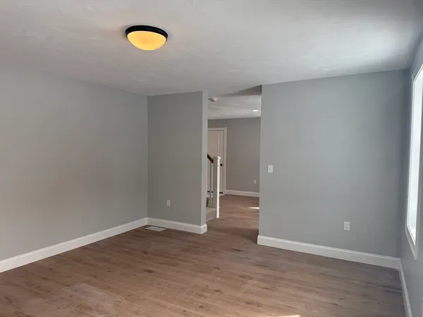 a view of a room with wooden floor