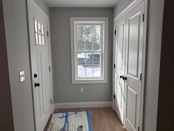 a view of a livingroom with a window and wooden floor